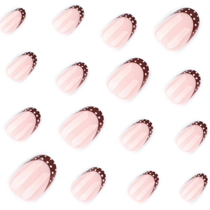 Short round French fake nails with brown tips and white polka dots on pink base