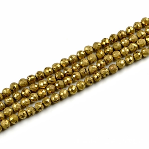 Close-up of faceted 10mm golden pyrite round beads showing shiny metallic texture
