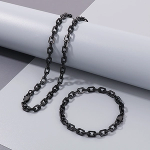 Detail of 7mm black stainless steel curb chain set with toggle clasp on aesthetic background