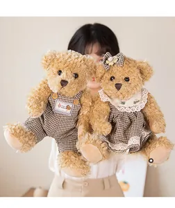Detailed close-up of plush teddy bear couple in matching brown checkered outfits