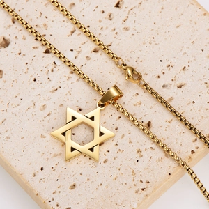 Gold stainless steel hollow hexagram star pendant necklace on a stone background