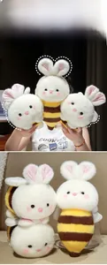 Close-up of soft bee rabbit plush toy with white fur and yellow brown stripes