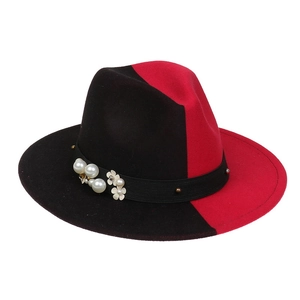 Detail of red and black gradient wool fedora hat with pearl and white flower band decoration