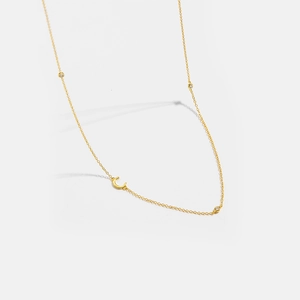 Detailed shot of S925 silver golden letter C necklace with three sparkling zircons