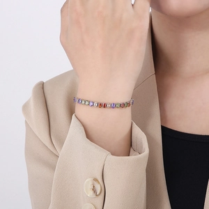 Close-up of colorful zircon tennis bracelet with silver finish on a woman wrist
