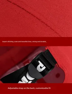 Close-up of adjustable strap and sewing detail on a red cotton baseball cap