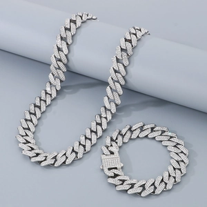 Close-up of silver-tone iced out Cuban link necklace and bracelet with clear rhinestones