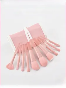 Close-up of peach makeup brush set with soft fiber bristles and matte translucent handles