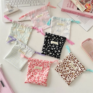 Set of cute printed drawstring pouches with cats and patterns for travel makeup storage