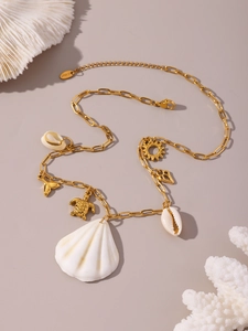 Detail of stainless steel necklace with gold turtle and white shell ocean pendants