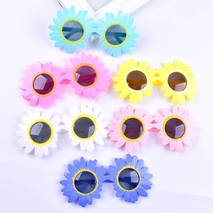 Flat lay of colorful daisy flower shaped plastic sunglasses for parties in six vibrant colors