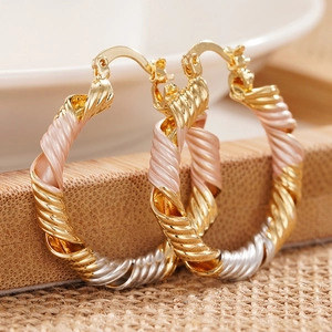 Three-tone twisted rope hoop earrings in gold silver and rose gold metal finish