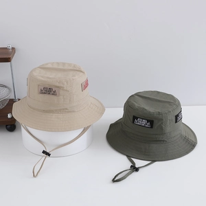 Detail of outdoor sun hats with adjustable wind ropes and nature themed logo patches