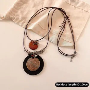 Detail view of double-layer bow necklace with long adjustable cord from 80 to 100cm