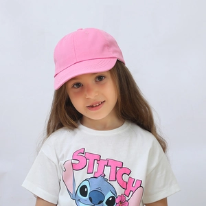 Close-up of pink cotton twill baseball cap for kids with adjustable strap and peak