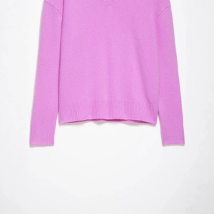 Lavender V-neck knit sweater featuring classic ribbed cuffs and a hemline for casual wear