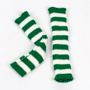 Detail of green and white striped knit arm warmers laid flat on a white background