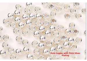 Macro detail of textured silver plated copper round spacer beads for jewelry making