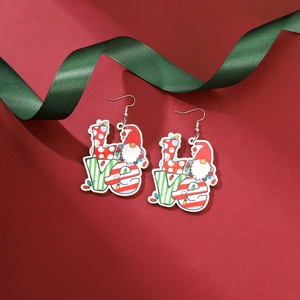 Detail of festive Christmas gnome earrings with LOVE letters on a red background