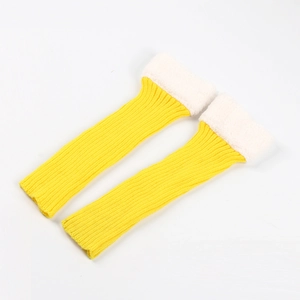 Detail of yellow knit leg warmers featuring white faux fur trim and soft ribbed texture