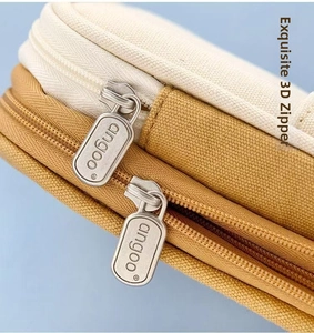 Close-up detail of smooth dual metal zippers on a canvas large-capacity pencil case