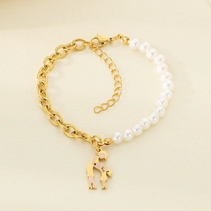 Detail of beaded pearl and gold titanium steel bracelet with a mother-child heart charm