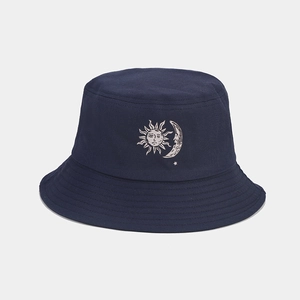 Dettaglio del cappello a secchiello blu scuro in cotone con stampa a trasferimento sole e luna