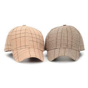Close-up of textured plaid pattern on vintage british style cotton baseball caps