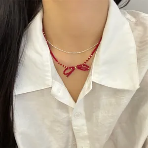 Double-layer handmade necklace with red faceted crystal beads and woven bow pendant