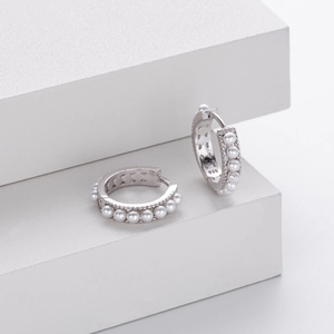 Detail shot of 925 sterling silver hoop earrings with white pearls and 925 hallmark stamp