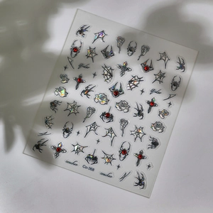 Gothic spider nail stickers with holographic web and cross designs on white background