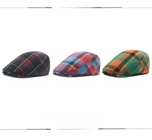 Detailed view of three plaid flat caps in blue, red, and green tartan patterns