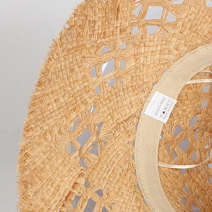 Close-up of 100% natural raffia straw hat inner brim with sweatband and label detail