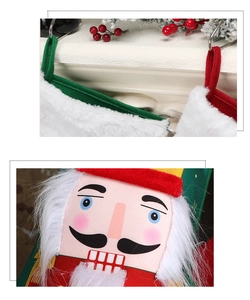 Detail of nutcracker embroidery and plush texture on a festive Christmas stocking hanging