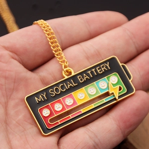 Detail of My Social Battery enamel necklace with sliding lightning bolt and colorful power bar