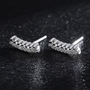 Sparkling double-row sterling silver stud earrings with cubic zirconia on black texture