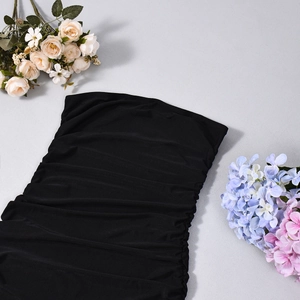 Detail of ruched fabric and off-shoulder design on a black bodycon maxi dress