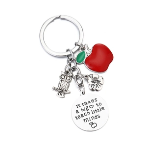 Teacher appreciation keychain with red apple, owl, flower charms and engraved metal pendant