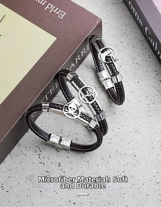 Detailed close-up of brown microfiber leather bracelets with stainless steel charms