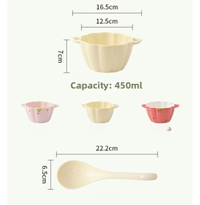 Close-up of strawberry ceramic bowl with double handles and matching spoon detail