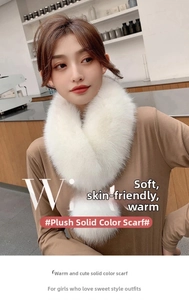 Close-up of white faux fur collar with pom-pom ribbons on model in cozy indoor setting