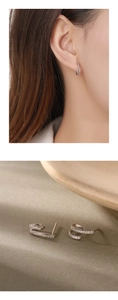 Detail of 925 sterling silver hoop earrings with white zircon on an Asian model