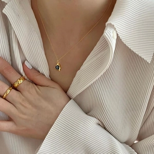 Elegant 925 silver gold necklace with black heart pendant and matching ring on model