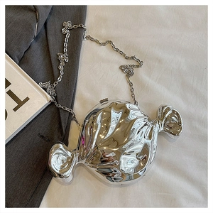 Detail of silver candy-shaped crossbody bag with liquid metal texture and chain strap