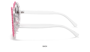 Side view of pink flower-shaped children's sunglasses with clear plastic frame
