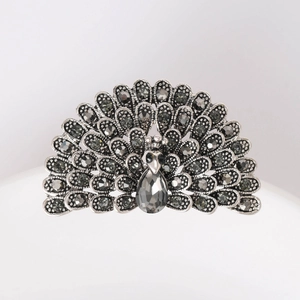 Detail of vintage peacock brooch with dark grey rhinestones and silver finish