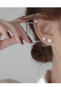 Detailed ear piercing view of silver heart studs in 3mm 4mm and 5mm sizes with cubic zirconia