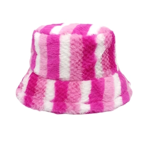 Detail of pink and white striped faux fur bucket hat with soft plush texture for winter