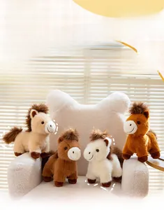 Detailed plush pony doll set in beige, brown, and white colors on a soft sofa