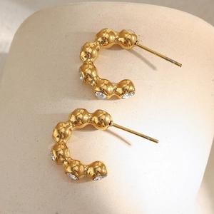 18K gold plated stainless steel beaded earrings with zircon stones on stone surface